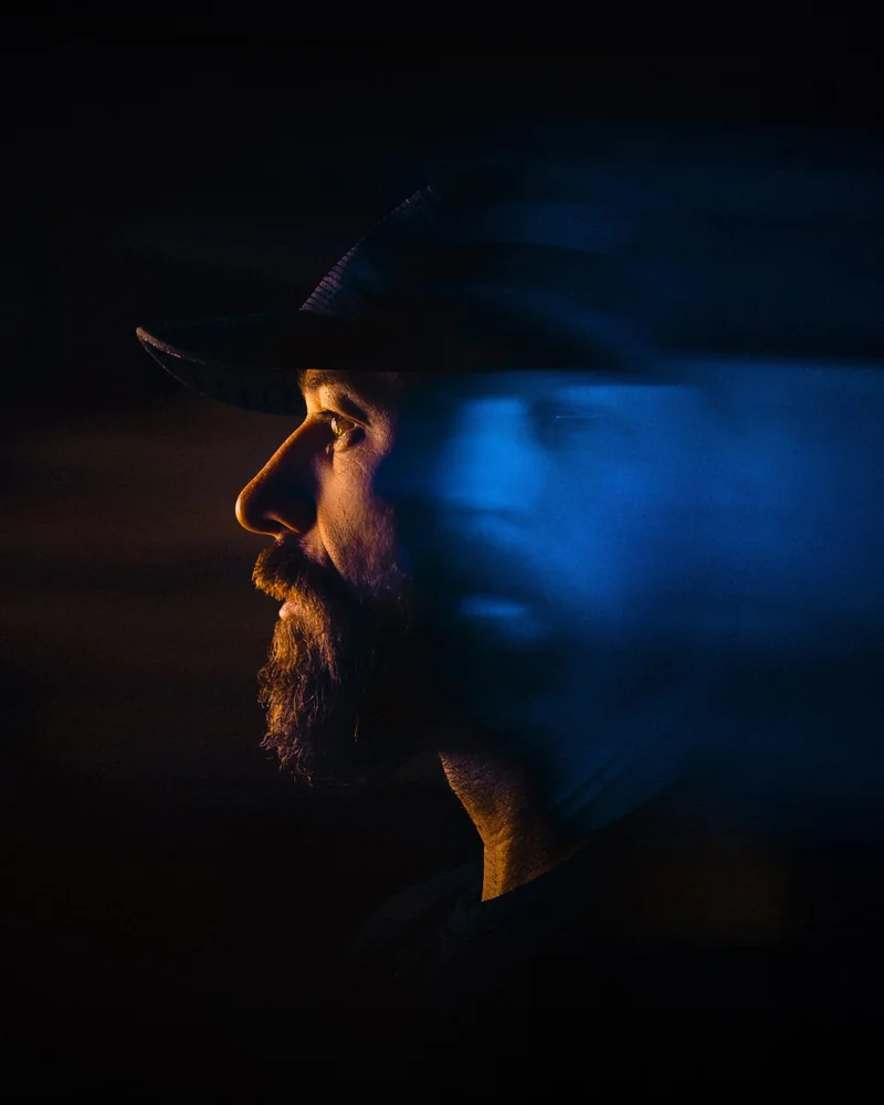 Mark Rutt, photographer, in profile with a blue motion blur